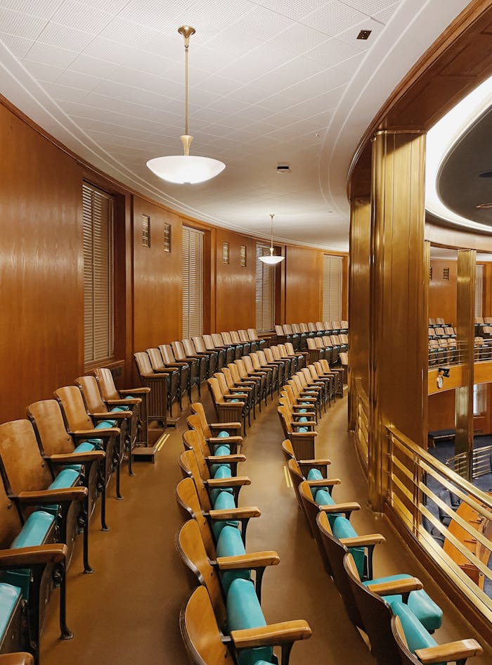 pexels-photo-14044481 Captivating view of a government chamber with elegant wood paneling and seating arrangement in Bismarck, ND.